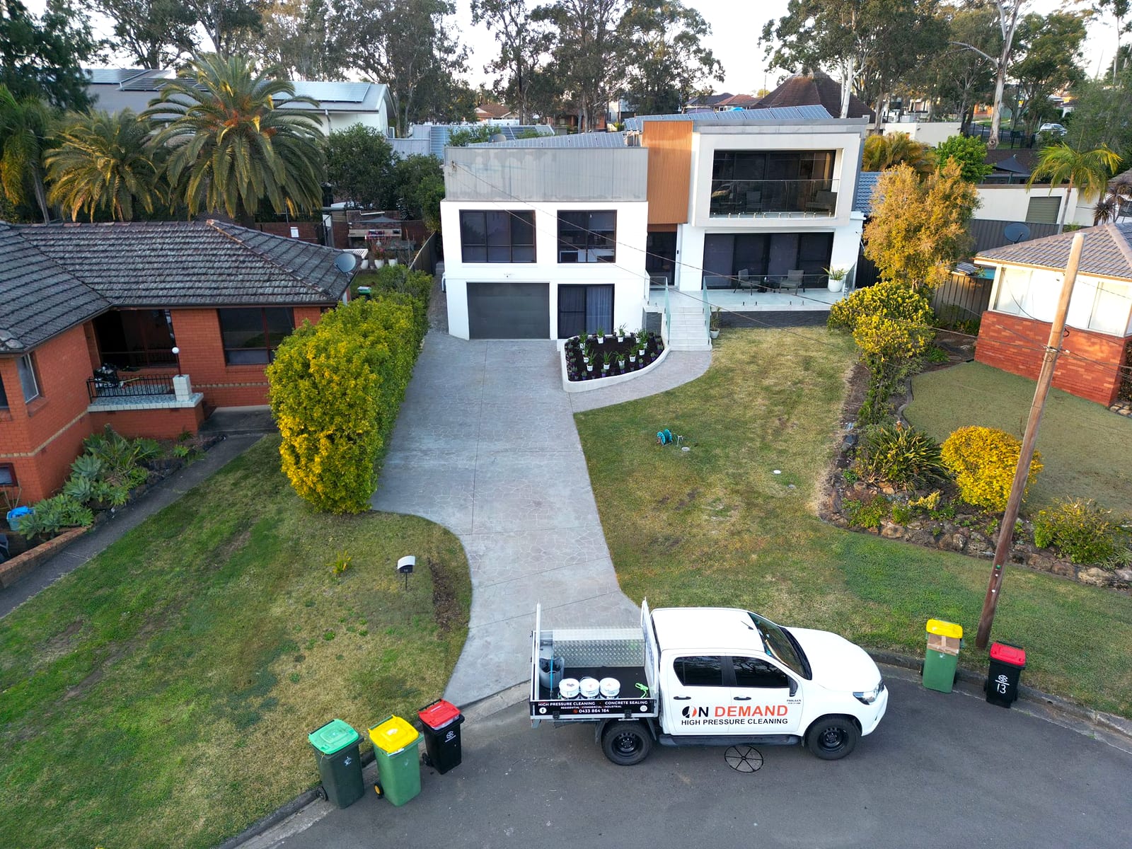 Driveway and property before high pressure cleaning, stained with algae and grime