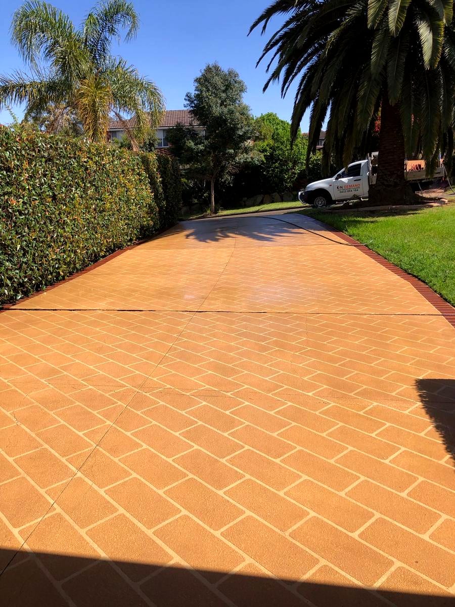 The same driveway after cleaning and a terracotta concrete seal, colour restored