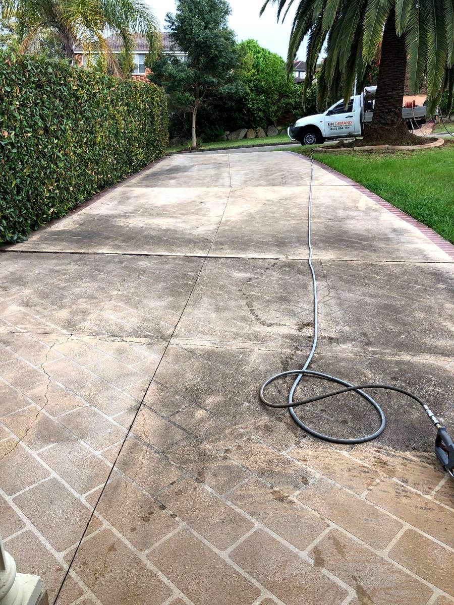 Faded grey concrete driveway before cleaning and sealing