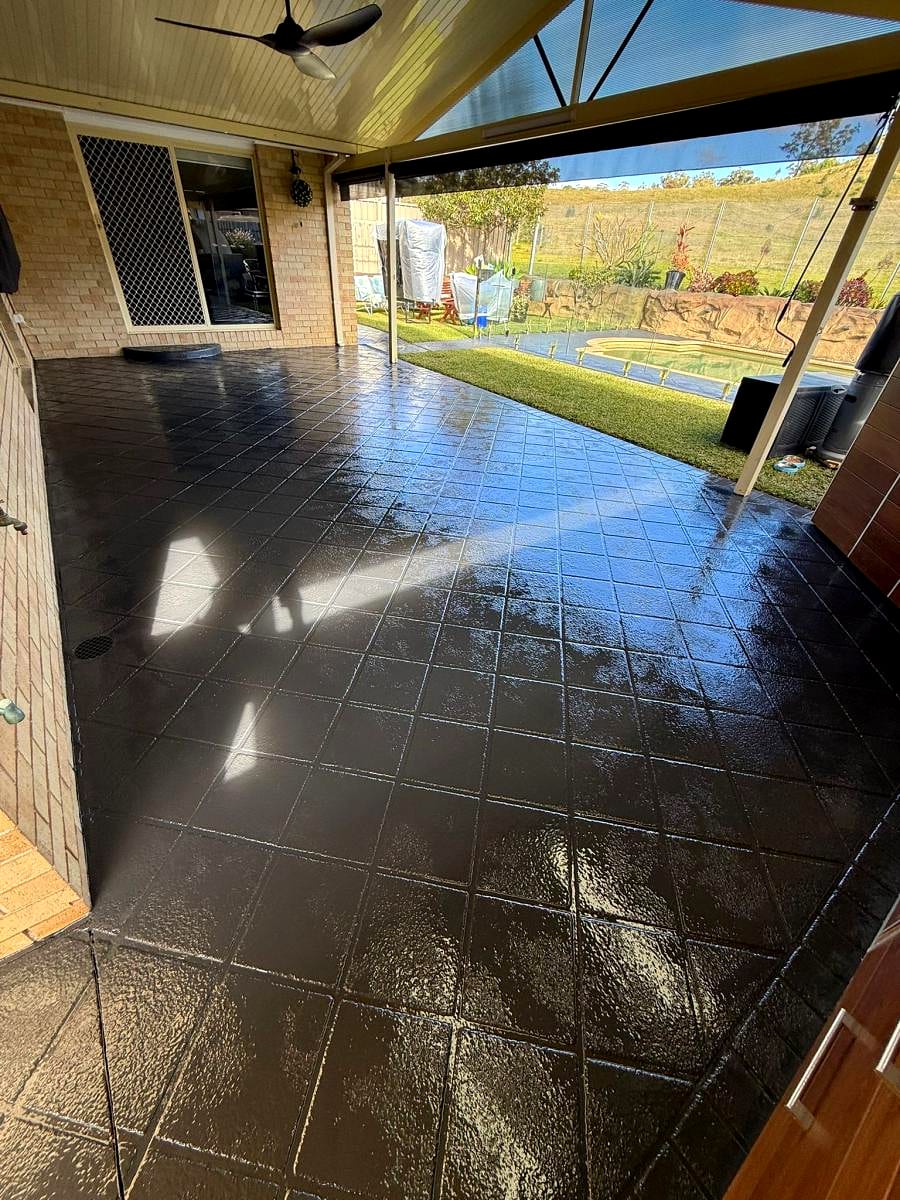 A concrete driveway with a fresh wet-look seal